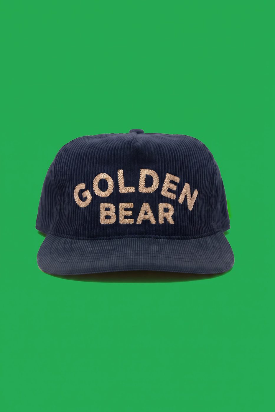 Navy corduroy snapback with oversized Golden Bear chenille lettering, on a kelly green background